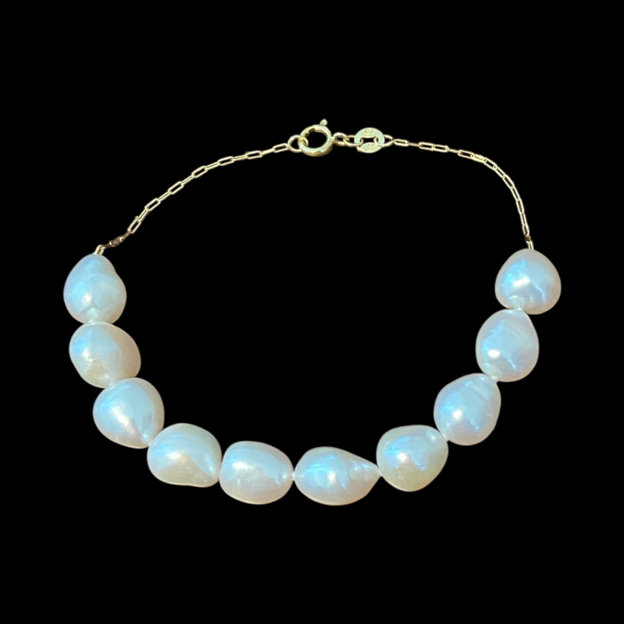 14k pearl bracelet on a black background