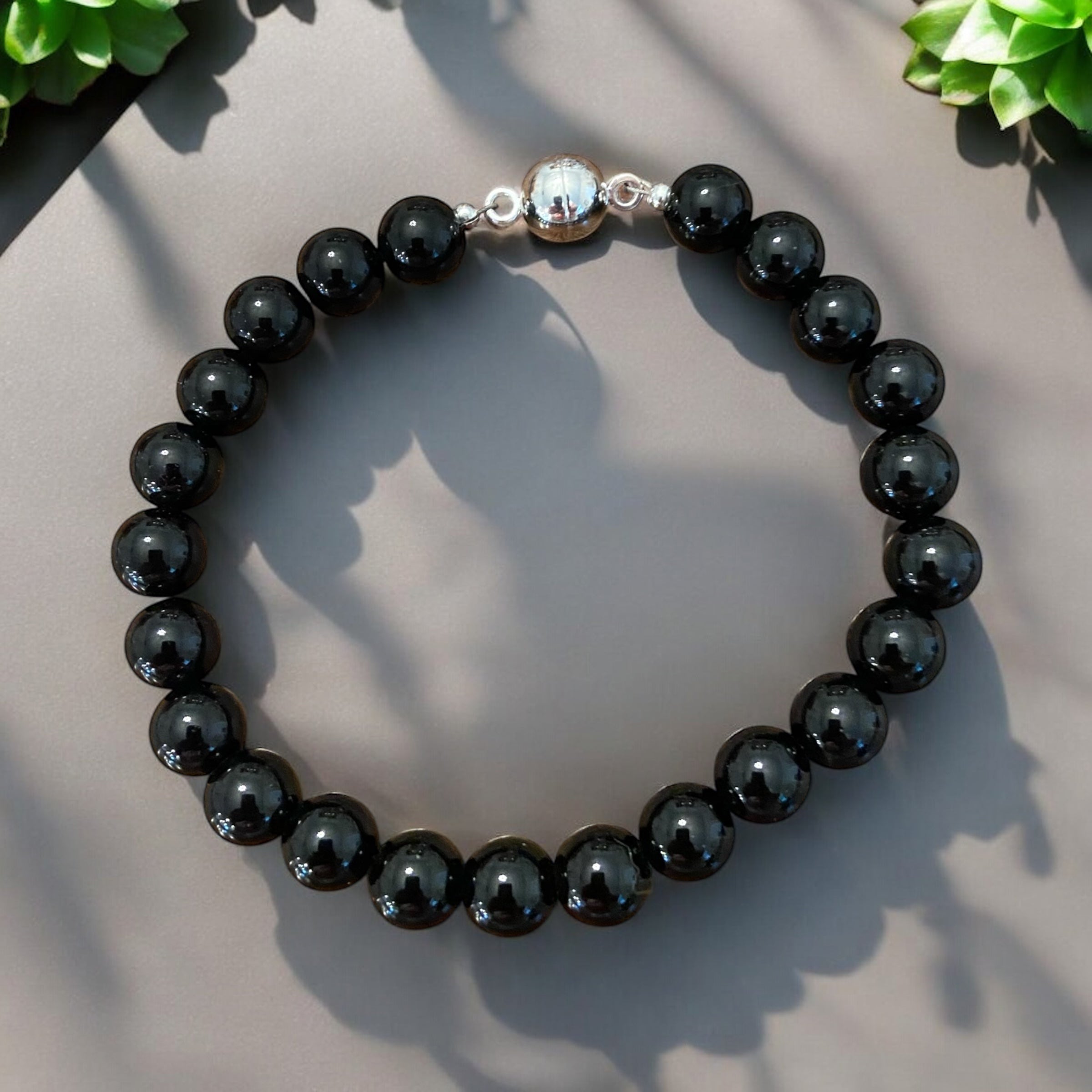 Men's polished black onyx 10 mm bracelet.