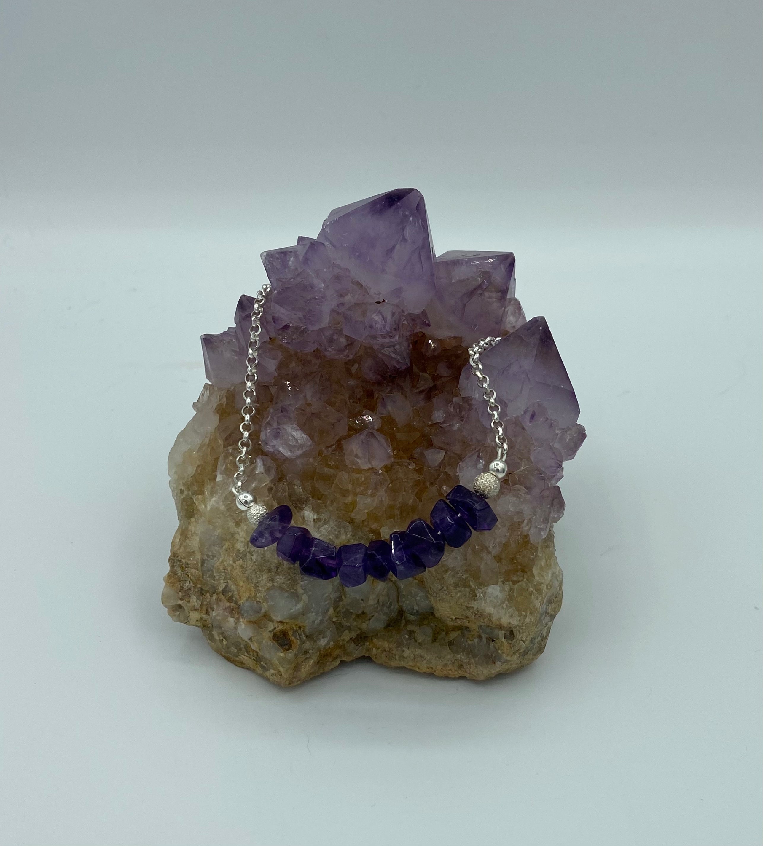 amethyst necklace on amethyst rock