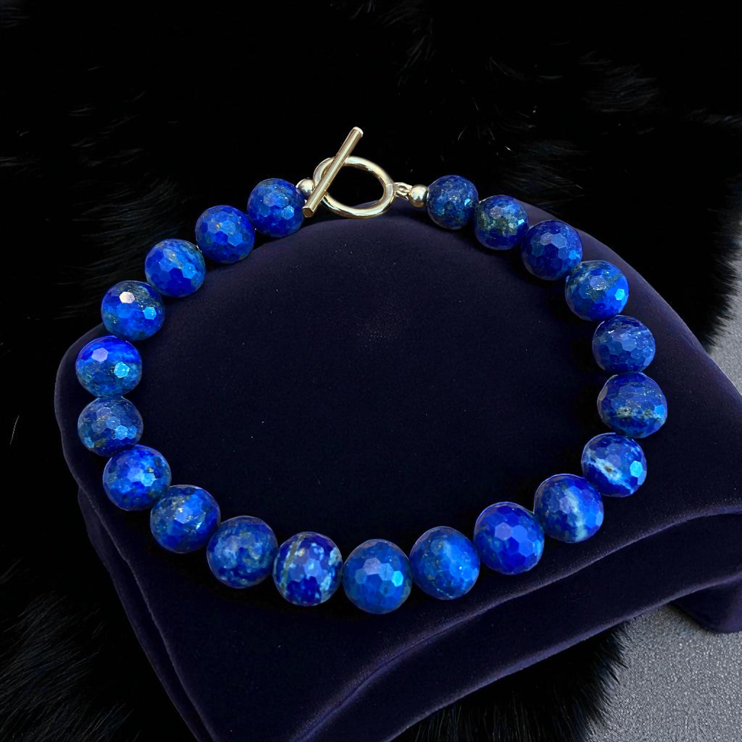 Lapis lazuli 10mm beaded bracelet with a 14k gold-filled toggle clasp.