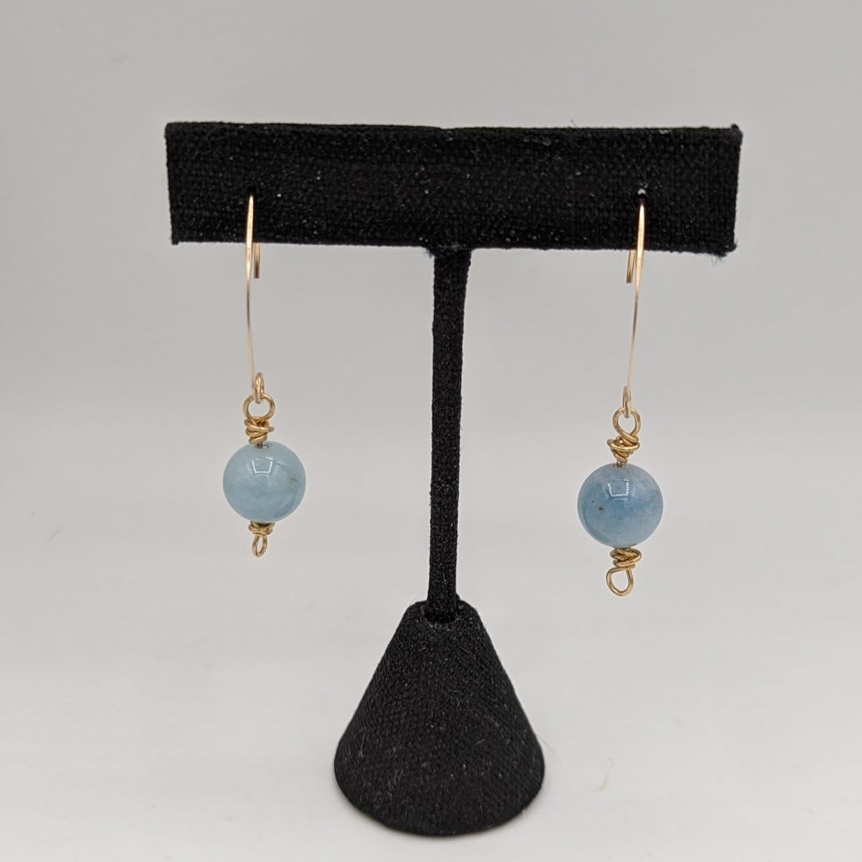 blue aquamarine earrings on black stand