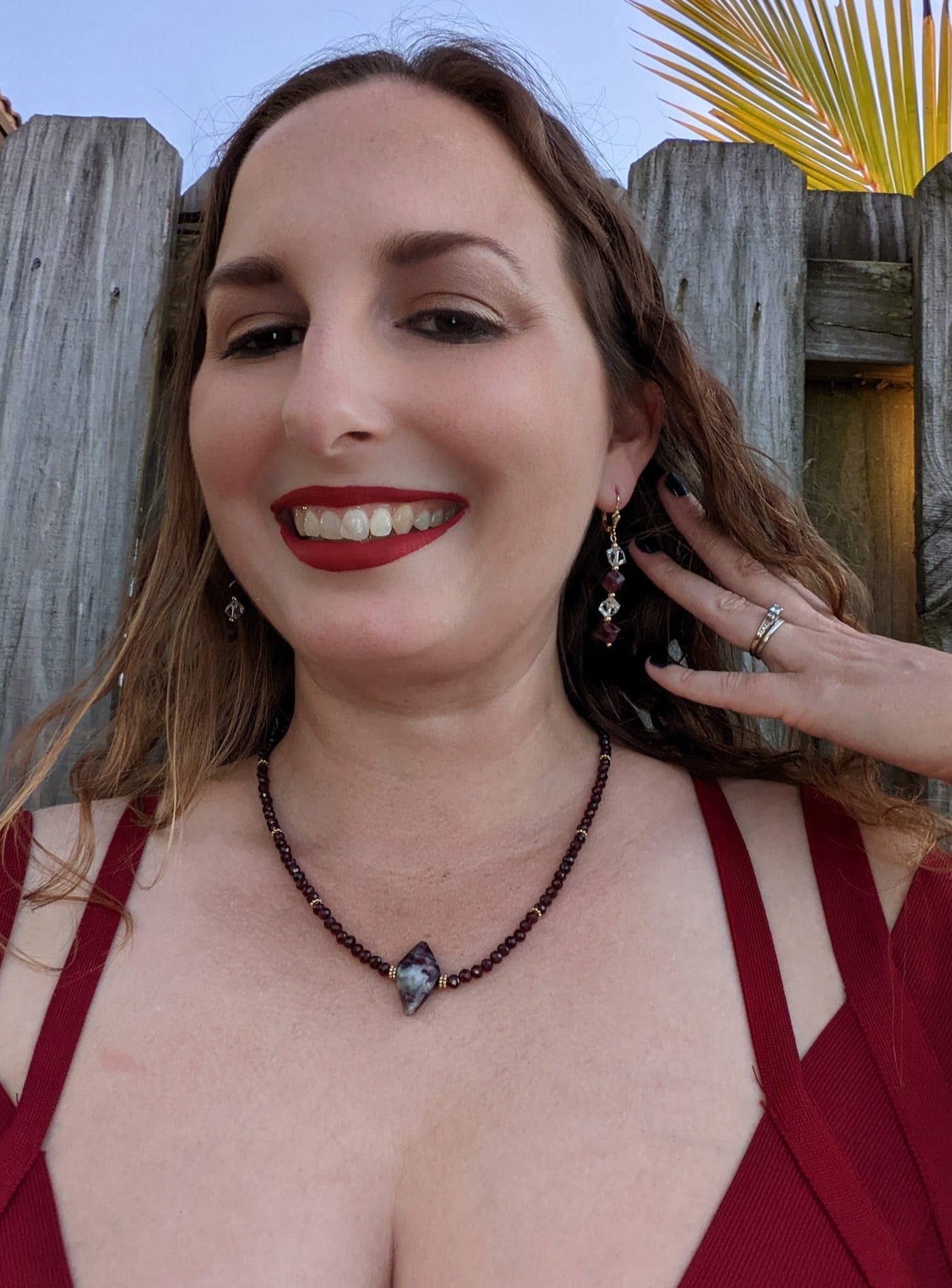 model wearing garnet and crystal earrings