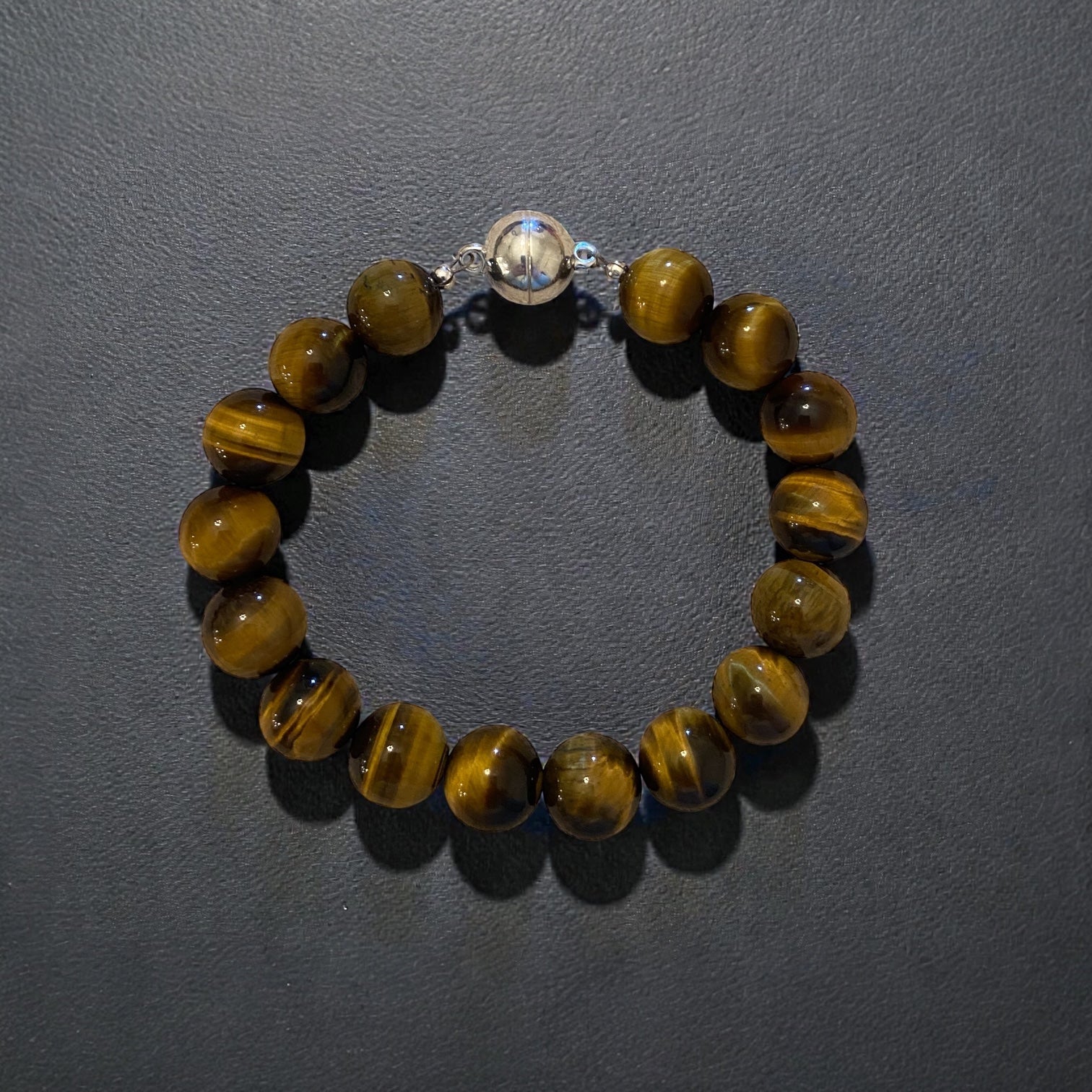 Bracelet with tiger eye beads with a sterling silver magnetic clasp.