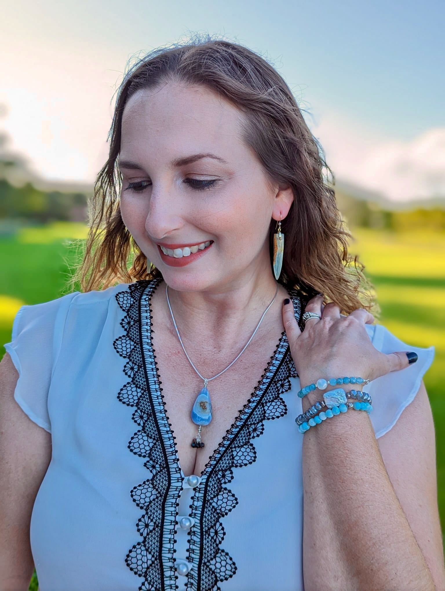model wearing blue chalcedony necklace and other associated matching pieces