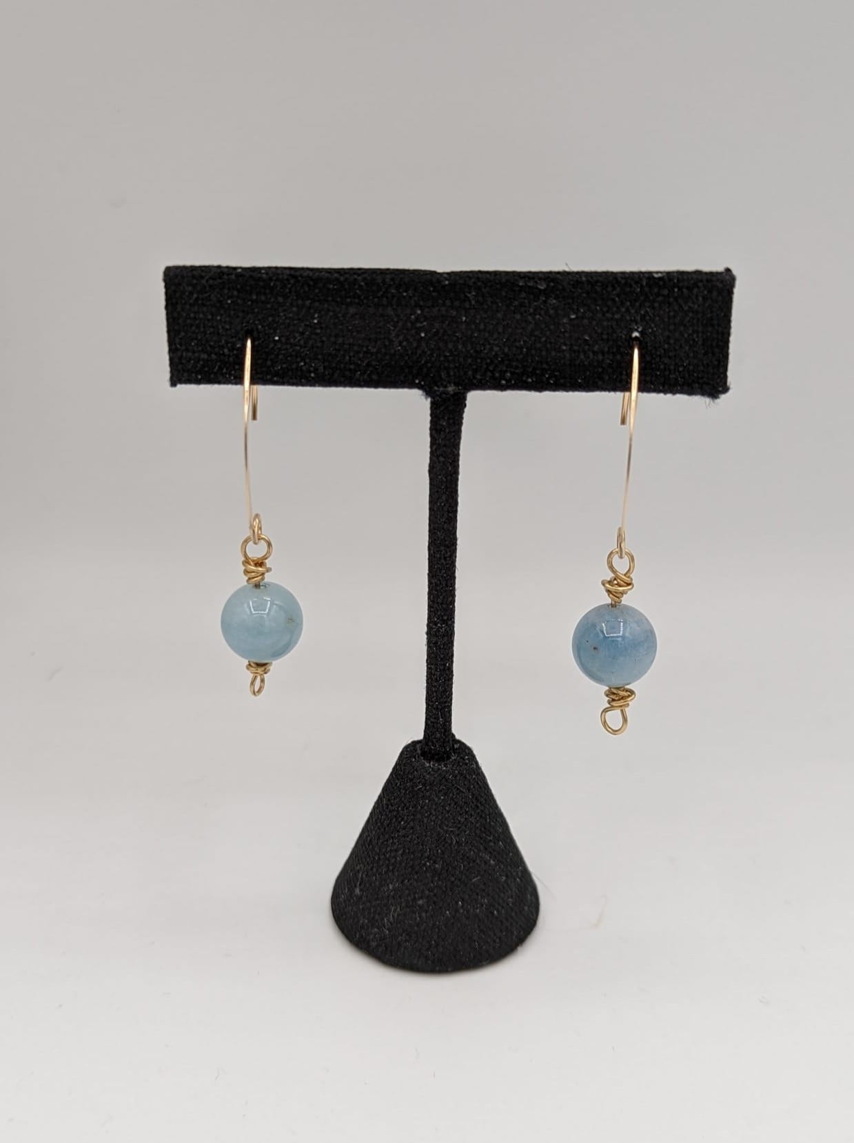 blue aquamarine earrings on black stand