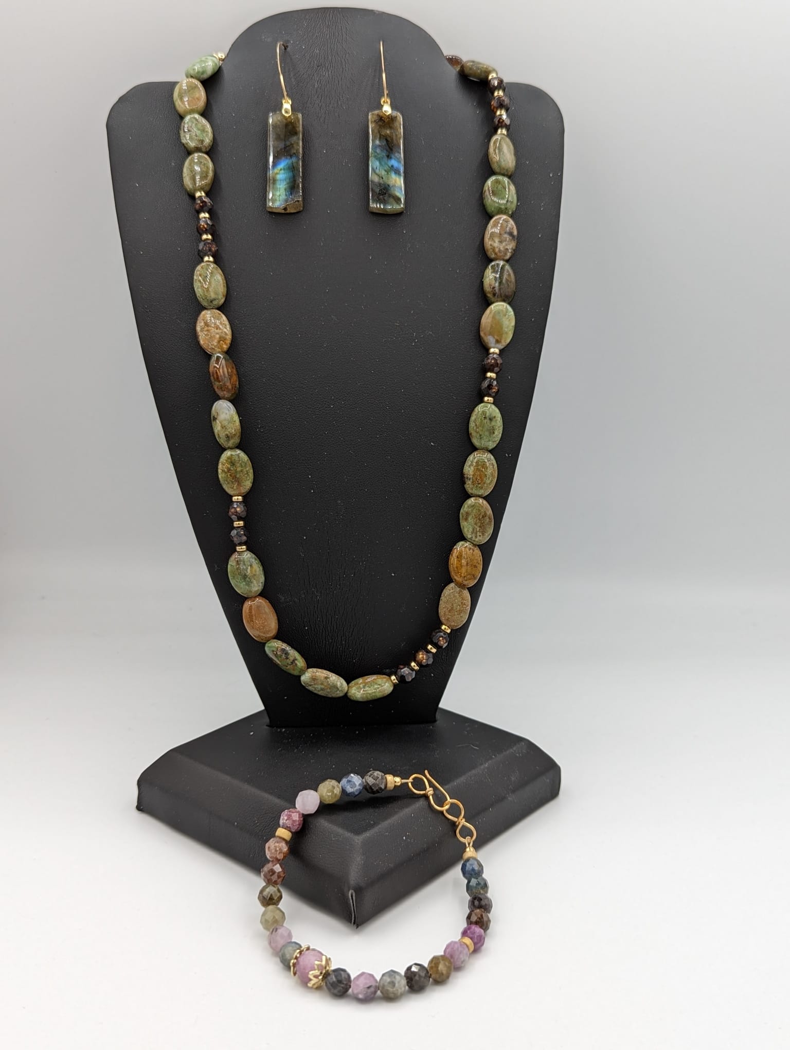 Australian opal necklace pictured with sapphire bracelet and laboradite earrings